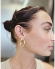 woman with diamond earrings accented with hoops